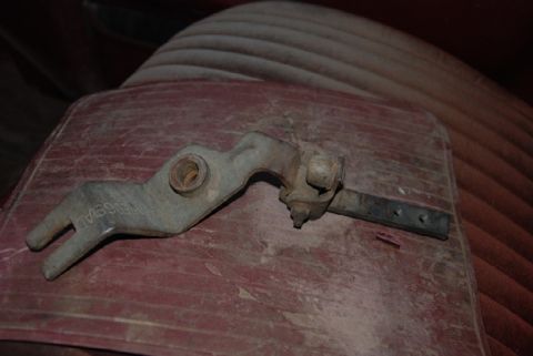 1987 Ford F-250 - A close-up view of a metal transfer case shifter lever with "NISSAN" visible on the part.
