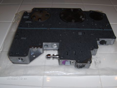 2004 Ford Crown Victoria - A close-up view of a transmission valve body, a critical component for automatic transmissions.