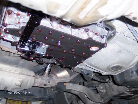 2004 Ford Crown Victoria - Close-up view of a vehicle's transmission valve body, showing its components and fluid.