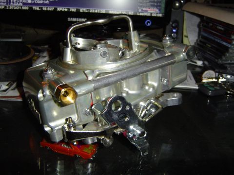 1978 Ford Bronco - A Holley carburetor is shown, with a small toy car underneath it.