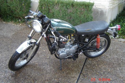 2006 Honda CBR-RR - A vintage green motorcycle with a black seat and chrome accents is parked outdoors on a paved surface.