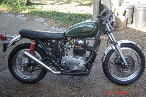 2006 Honda CBR-RR - A vintage Yamaha motorcycle with a green fuel tank and chrome accents is parked outdoors.