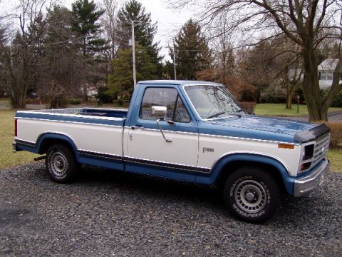 1984 Ford F-150 - This two-tone pickup truck features a blue stripe separating the white cab and bed from the lower blue body.
