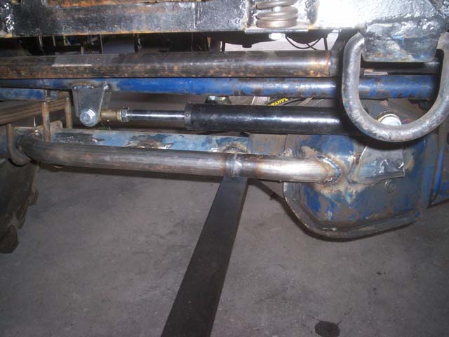 Close-up of custom steering linkage and suspension parts on a vehicle