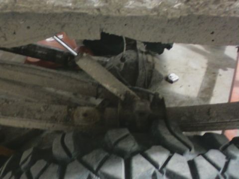 1992 Ford F-350 - Close-up view of the rear axle and suspension components of a vehicle.