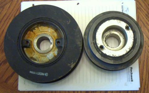 1997 Ford Taurus - Two automotive pulleys are shown side-by-side on a white paper with lines.