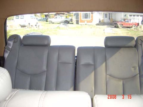 1983 Ford Bronco - View from inside a vehicle, showing seats and a scene with multiple vehicles outside.