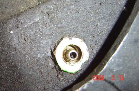 1983 Ford Bronco - A close-up view of a tire's valve stem, with a date stamp and website visible in the corner.