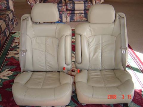 1983 Ford Bronco - Two tan leather car seats are shown from the front, placed on a rug.