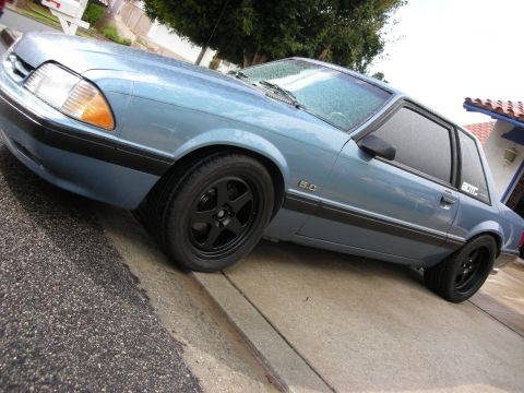 1990 Ford Mustang - This 1990 Ford Mustang coupe features a light blue paint job and black aftermarket wheels.