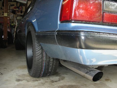1990 Ford Mustang - Close-up of a 1990 Ford Mustang's rear, showing the taillight and exhaust system.