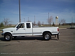 1992 Ford F-250 - This white 1992 Ford F-250 crew cab pickup truck is shown from the side in a parking lot.