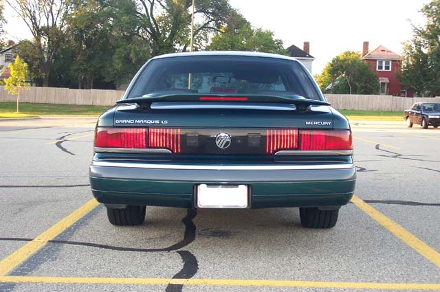 Rear view of green Mercury Grand Marquis LS, full-width taillights and trunk badge