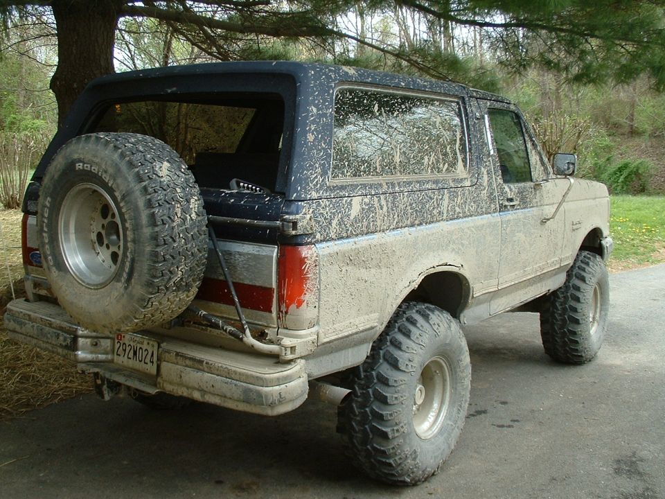 1991 Ford Bronco rear view, mud-splattered with spare tire