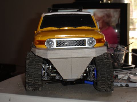 1996 Ford Bronco - A yellow toy FJ Cruiser with a custom front bumper and off-road tires sits on a table.