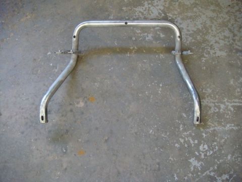 1996 Ford Bronco - Bare-metal tubular roll bar hoop stripped of finish, with small mounting brackets at the upper bends and flat mounting feet, laid on a stai…