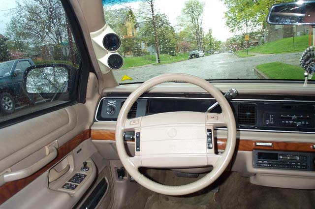 Tan interior and dash of a Mercury luxury sedan viewed from driver's side