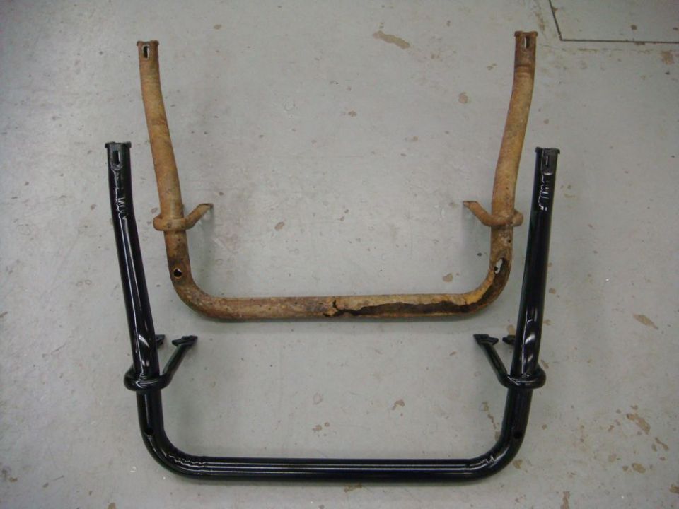 Rusty tubular truck bracket next to an identical freshly painted gloss black one on a shop floor