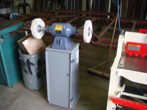 1996 Ford Bronco - Buffing machine on a cabinet in a workshop setting. Other tools and equipment are visible.