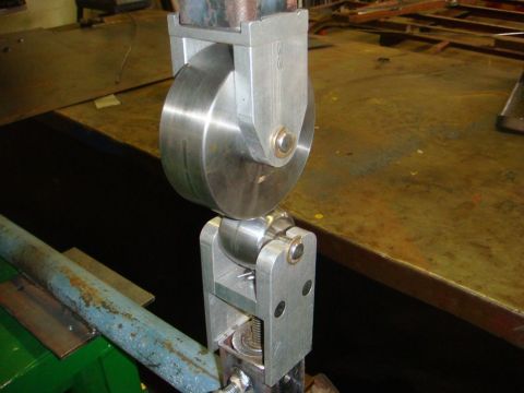 1996 Ford Bronco - A close-up view of a sheet metal roller tool, commonly found in auto body shops for shaping metal.