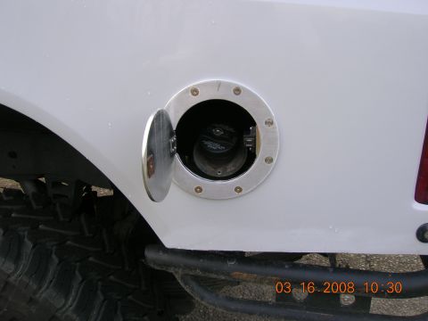 1996 Ford Bronco - Close-up of a white SUV's open fuel door and a portion of a large tire, with a timestamp in the corner.