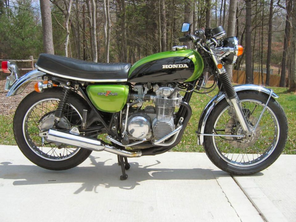 Green and black Honda CB500 Four motorcycle side view with 4-into-4 chrome exhaust
