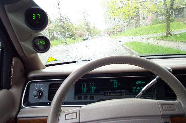 Car dashboard with dash-mounted gauges and digital instrument cluster