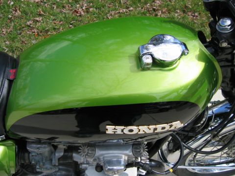 1985 Ford Crown Victoria LTD - Close-up of a Honda motorcycle's fuel tank and engine components.