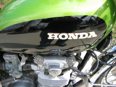 1985 Ford Crown Victoria LTD - A detailed view of a Honda motorcycle's engine and fuel tank, showing the iconic 'HONDA' lettering.