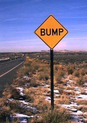 1992 Ford Mustang - A warning sign alerts drivers to an upcoming bump on a desolate highway.