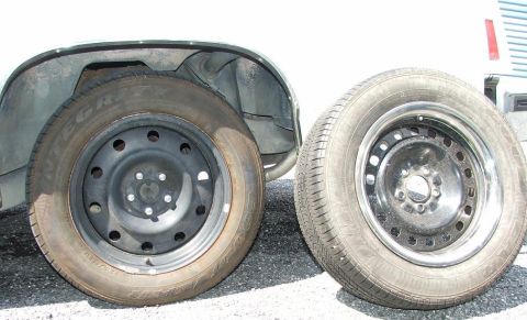 1985 Ford Crown Victoria LTD - A tire on a car and a spare tire are shown side-by-side.