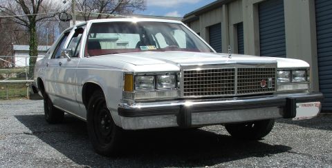 1985 Ford Crown Victoria LTD - This sedan has a prominent chrome grille and a Virginia license plate.