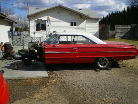 1964 Ford Galaxie - This 1964 Ford Galaxie is undergoing front-end work, with the engine and chassis components exposed.