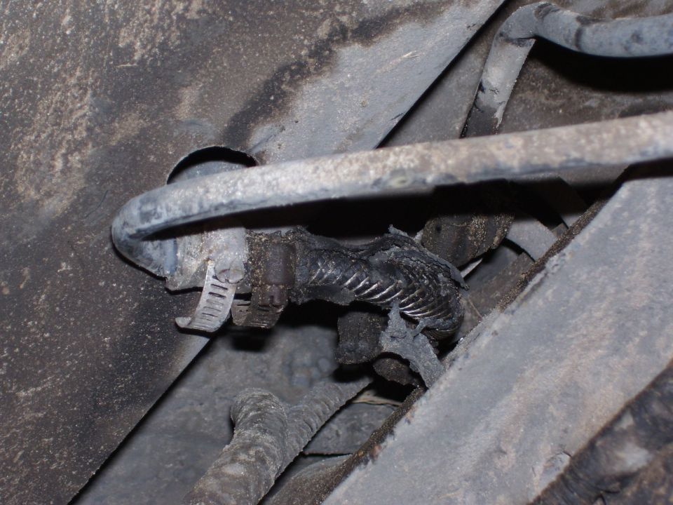 Close-up of a corroded undercarriage component and wiring