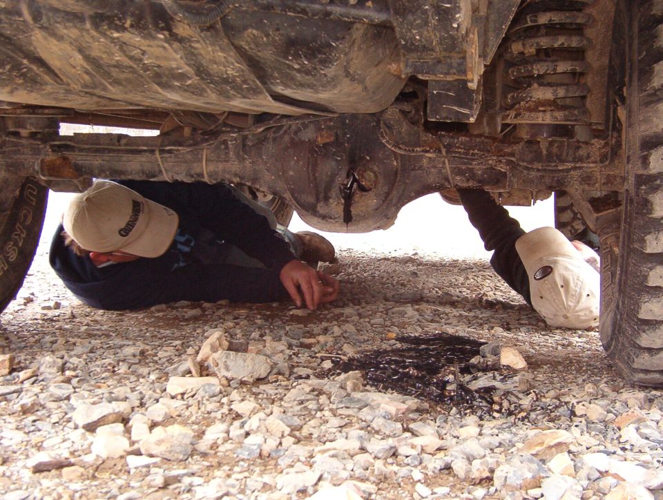 After pulling the axleshafts, Greg drove ~100' down to the office to air up and discovered a fresh hole punched out of his rear diff (we didn't hear anything, but it wasn't there when we pulled the shafts).  So he had to also pull the rear d'shaft off the t-case & tie it up.