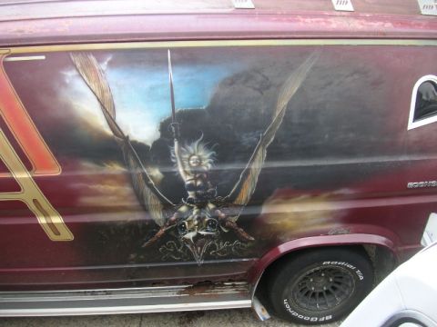 1979 Ford F-250 - This van features a custom airbrushed mural on its side, depicting a fantasy scene with a winged figure.