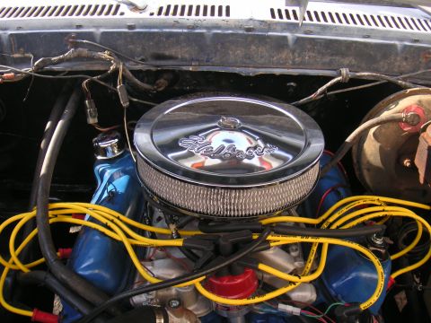 1979 Ford F-250 - Close-up of an engine bay a chrome Edelbrock air cleaner and bright yellow spark plug wires.
