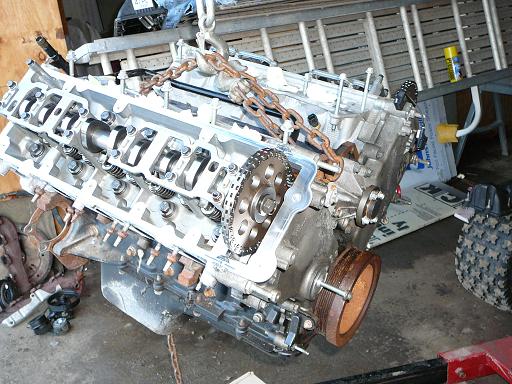 Engine block with timing chain and pulley suspended by chains