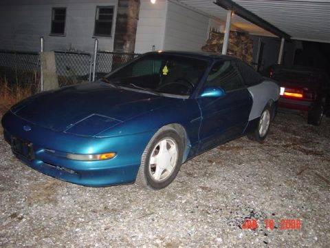 1993 Ford Probe - This 1993 Ford Probe is seen in a driveway with a primer-gray rear quarter panel.
