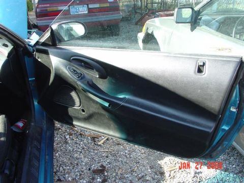 1993 Ford Probe - The interior door panel of a car, with other vehicles visible outside.