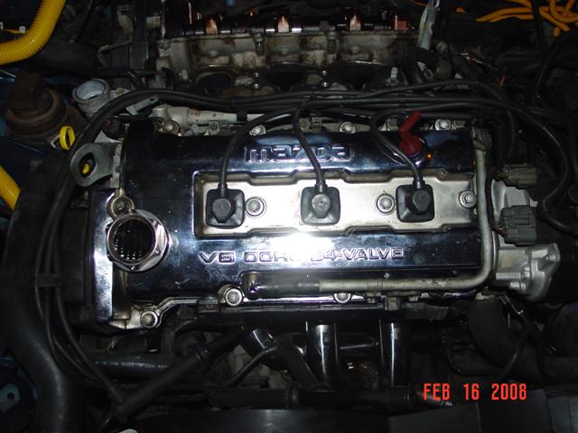 Mazda V6 DOHC 24-valve engine cover with yellow hoses and wiring
