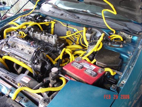 1993 Ford Probe - The engine bay is filled with yellow hoses and a red battery. Text in the corner indicates the photo was taken on February 29, 2008.