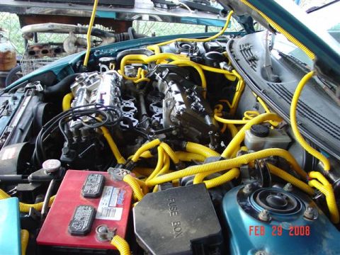 1993 Ford Probe - Engine bay of a teal car with extensive yellow hose modifications, dated February 29, 2008.