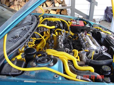 1993 Ford Probe - Engine bay with yellow tubing and a chrome intake manifold. Date stamp reads FEB 29 2008.