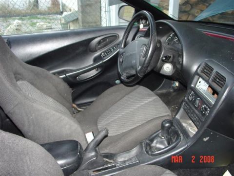 1993 Ford Probe - Interior view of a 1993 Ford Probe, showing the dashboard, steering wheel, and seats. A date stamp indicates the photo was taken on March 2…