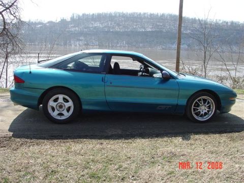 1993 Ford Probe - Side view of a teal 1993 Ford Probe GT with a GT badge on the lower door.