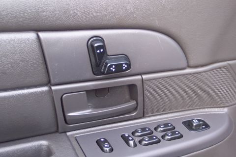 2001 Ford Crown Victoria - The interior door panel shows power seat and window controls, along with the door handle.