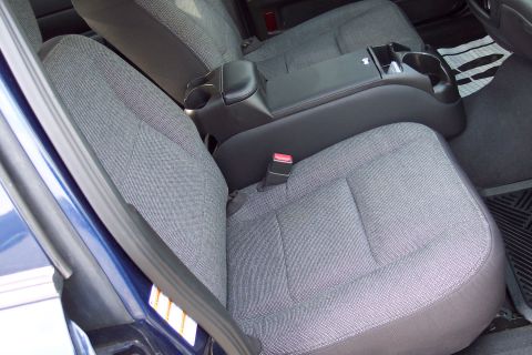 2001 Ford Crown Victoria - Interior view of car seats and center console with cup holders.