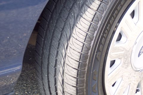 2001 Ford Crown Victoria - Close-up of a tire and wheel assembly, showing tire tread and wheel details.