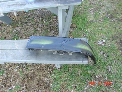 1993 Ford Probe - A car taillight assembly is shown with green spray paint marks on its surface.
